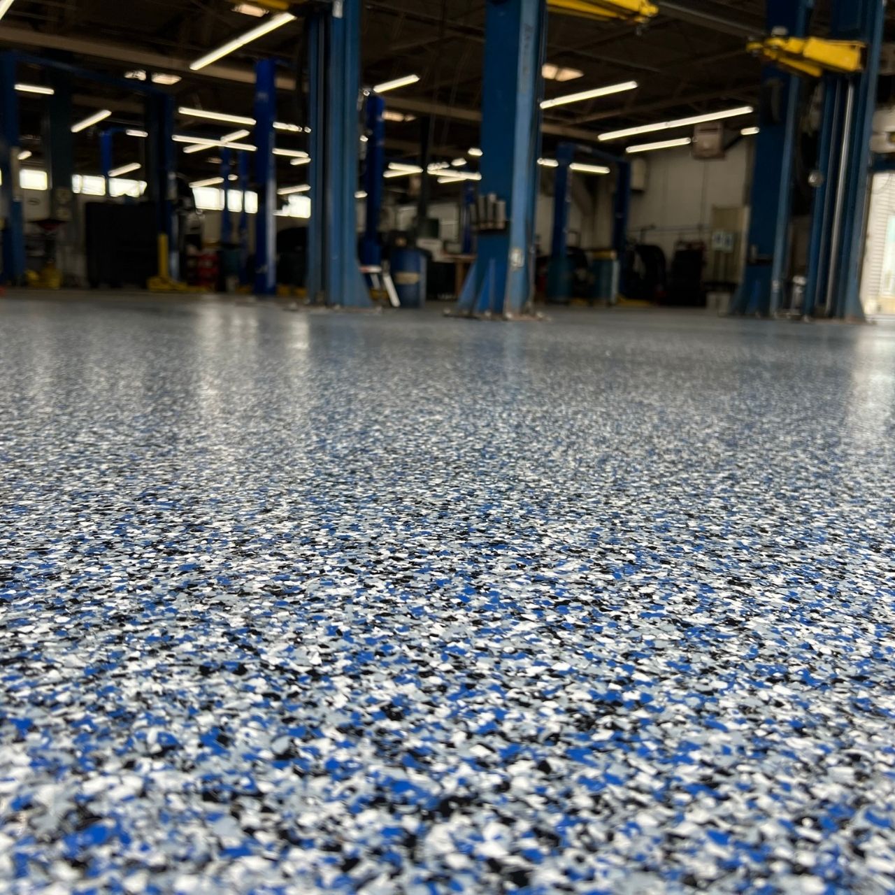 Blue full flake polyaspartic auto shop floor coating — Shipp-Mates Epoxy of the Ozarks
